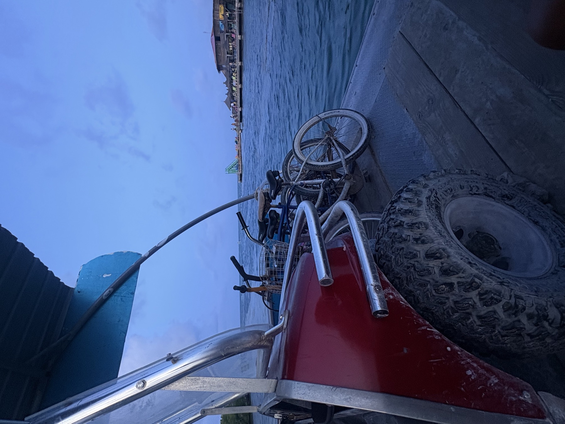 Golf cart with a bicycle on the back, sea behind