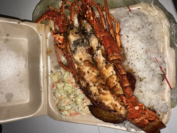 Grilled lobster in a styrofoam box